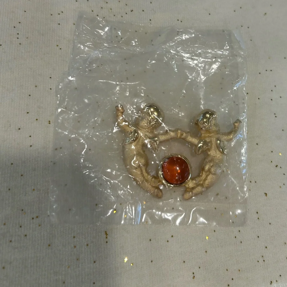 New Vintage Louis Stern (LS) gold-tone cherub brooch with a faux amber cabochon.